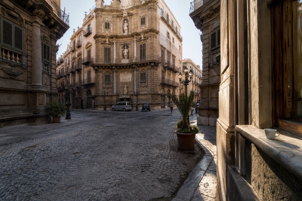 A sunlit cobblestone square in Palermo's historic centre