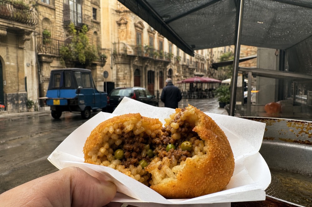 Sicilian rice snack filling of meat ragu and peas in a fried breadcrumb shell