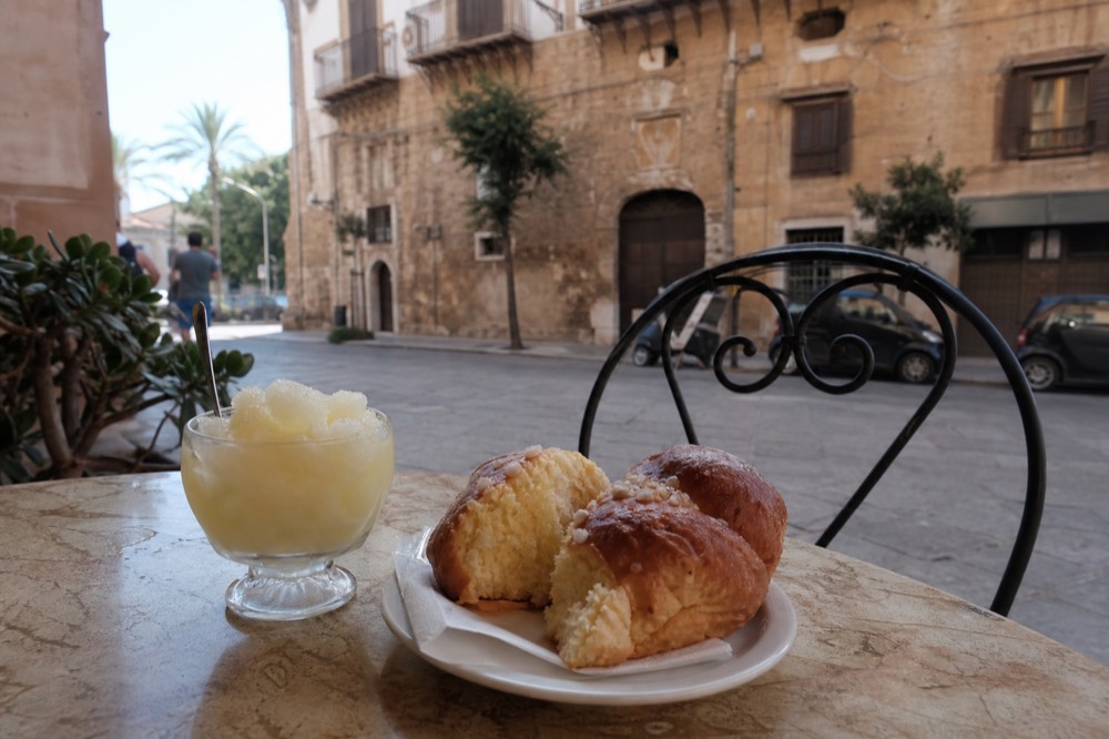 Sicilian lemon granita with a sweet brioche on a cafe table