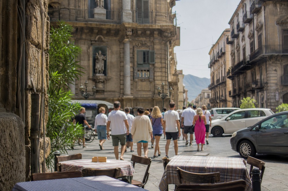 Crowded Palermo pedestrian street with market crowds and outdoor tables