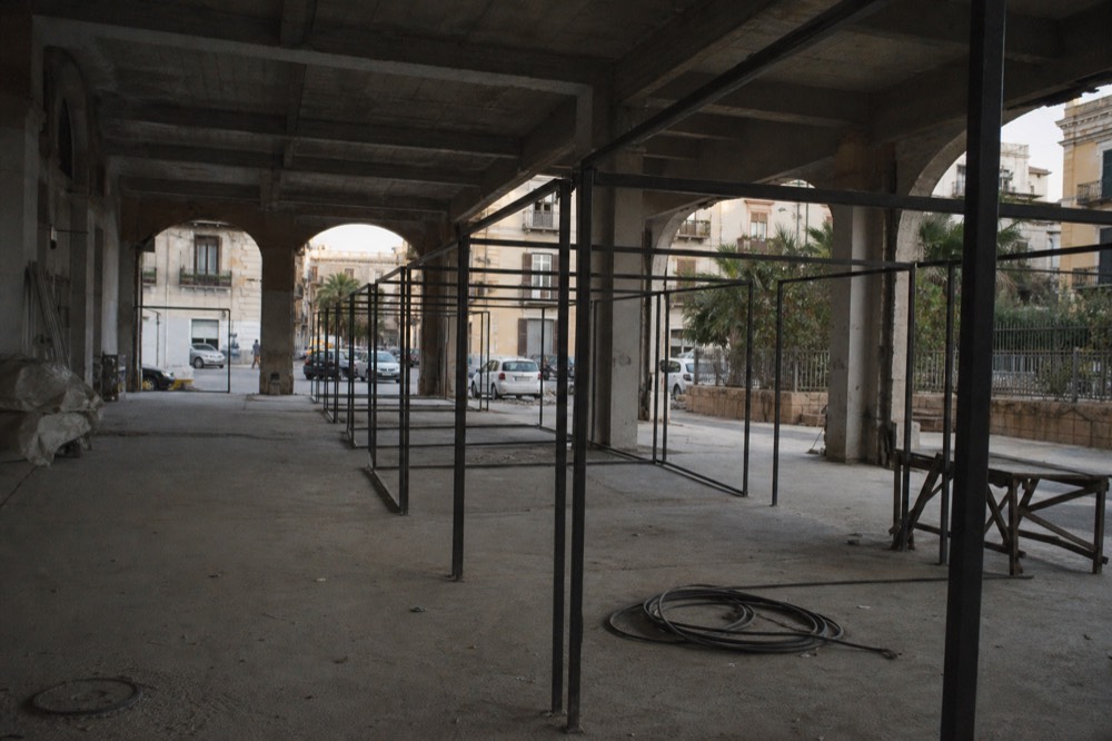 Covered market building with empty stall structures under a roof