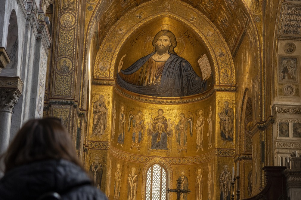 Golden mosaics covering the interior of a Norman cathedral apse