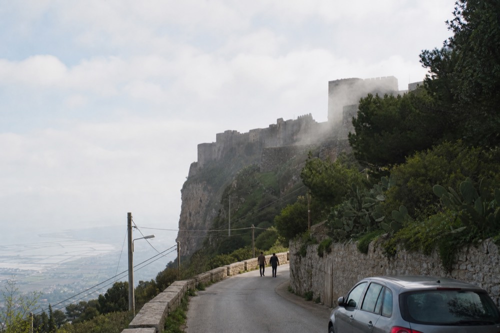 A stone hill town with narrow lanes sitting above a coastal plain