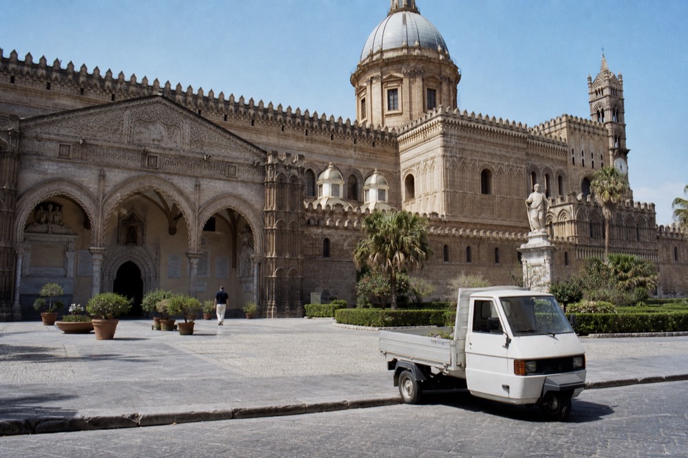 The ornate exterior of a Norman church in Palermo under a clear sky