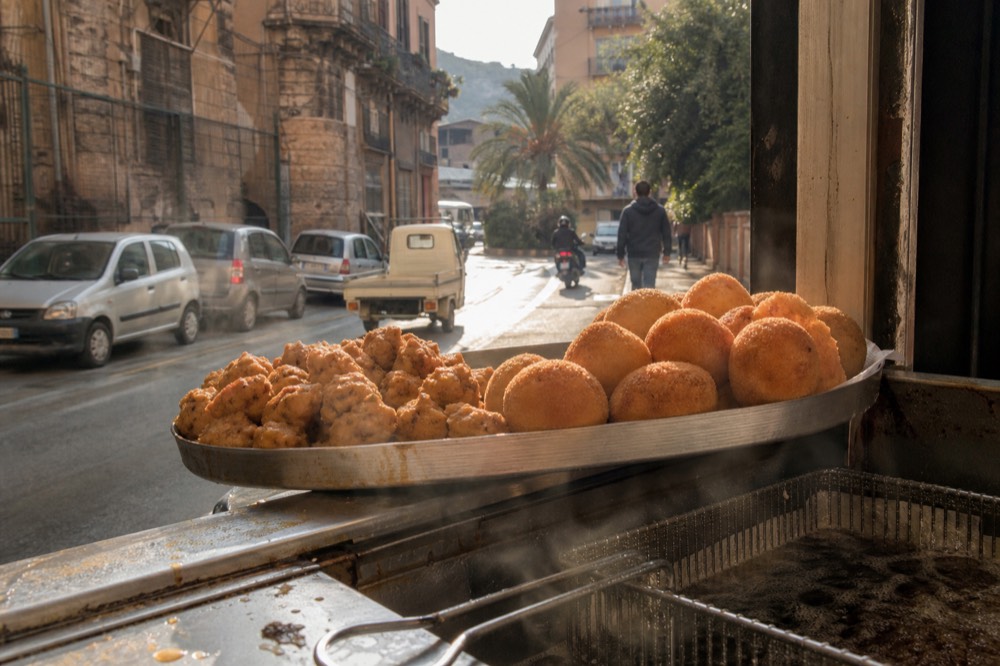 Golden fried arancine and chickpea fritters on a tray