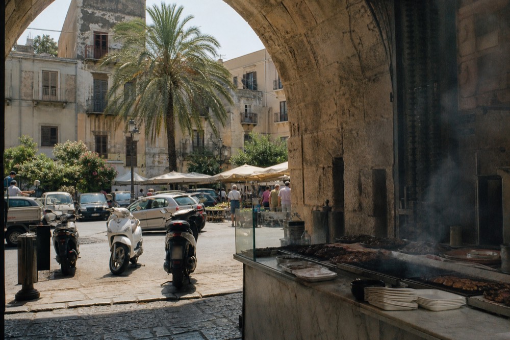 Street food counters along the Capo market street in Palermo
