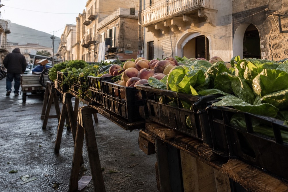 Fresh produce stacked in crates at an early morning Palermo market