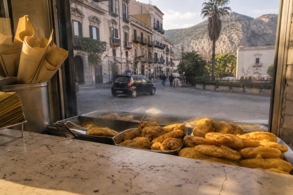 Fried snacks displayed in a glass counter at a Palermo friggitoria